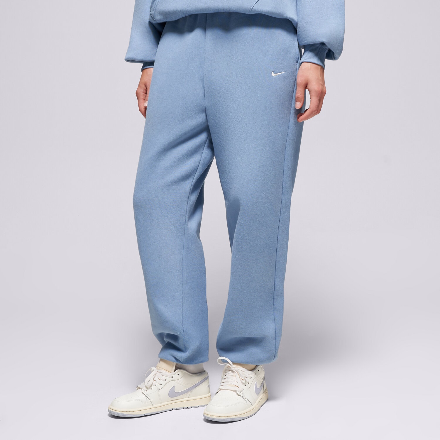 Spodnie sportowe damskie NIKE SPODNIE W NK STDO FLC OS CFF PNT IM8074-486 NIEBIESKI