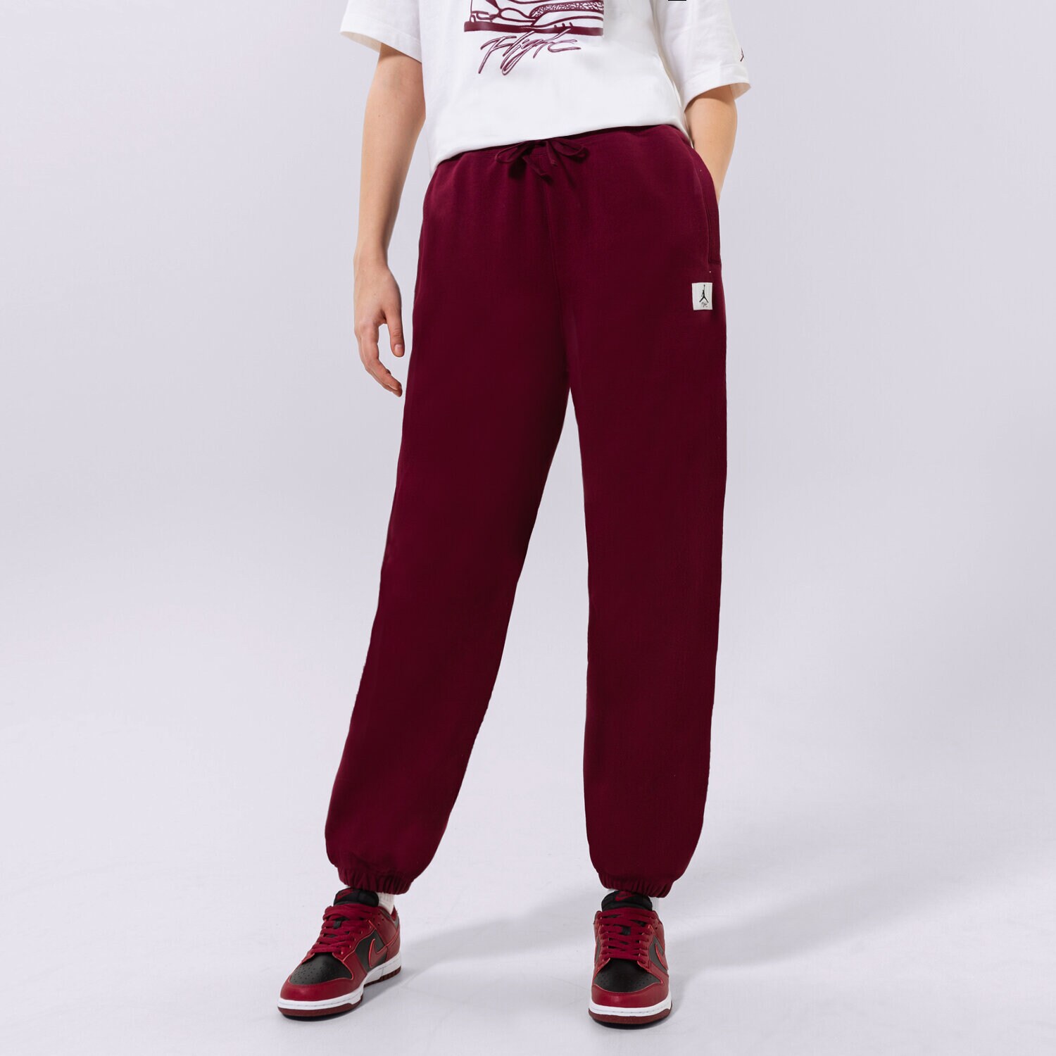 Spodnie sportowe damskie JORDAN SPODNIE W J FLT FLC PANT DQ4607-645 BORDOWY